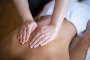 hands on back, giving massage